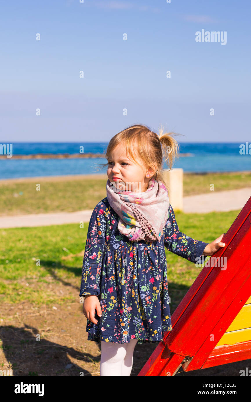Portrait of beautiful young baby girl on the playground Stock Photo - Alamy
