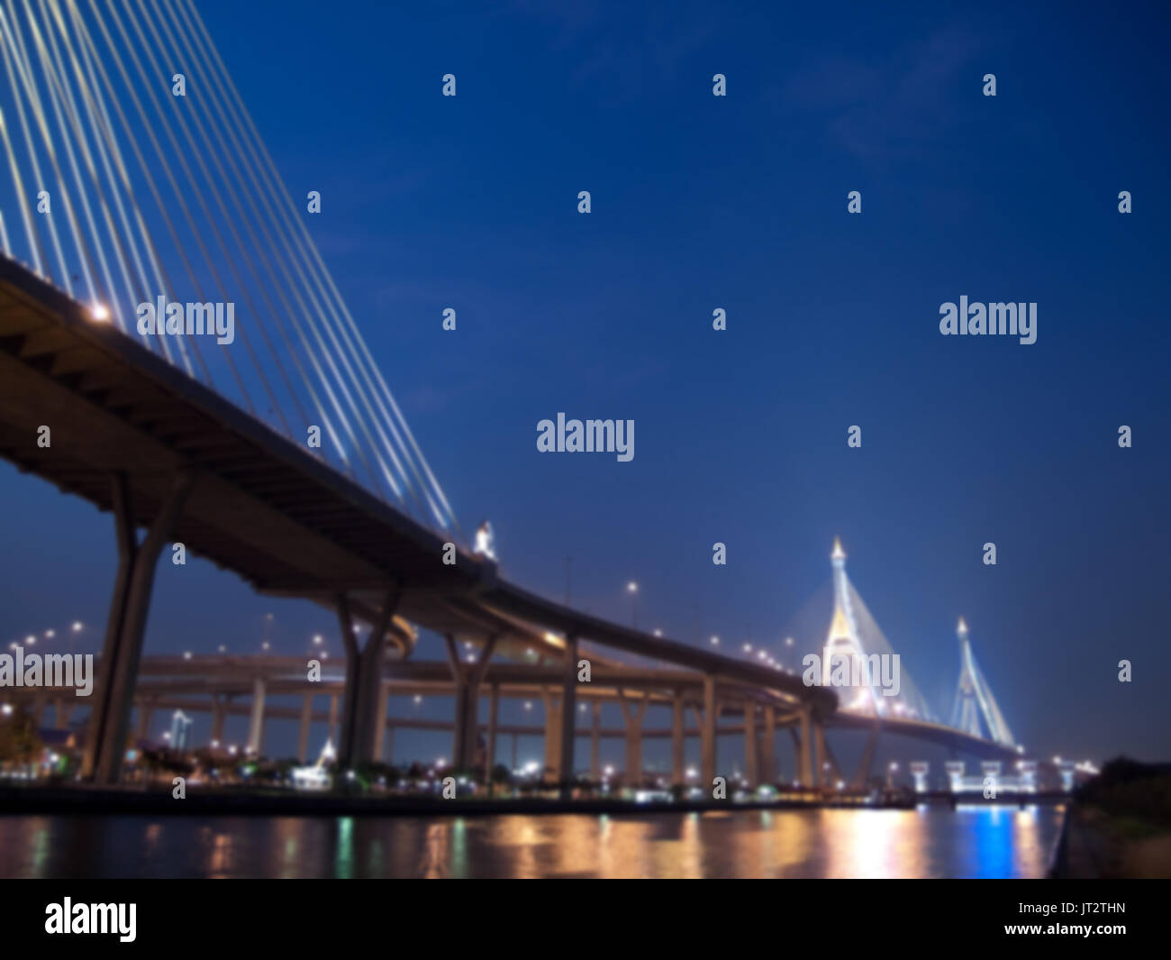 Blurred Bhumibol bridge with floodgate illuminate with spotlight at night scene, Samut Prakarn,Thailand Stock Photo