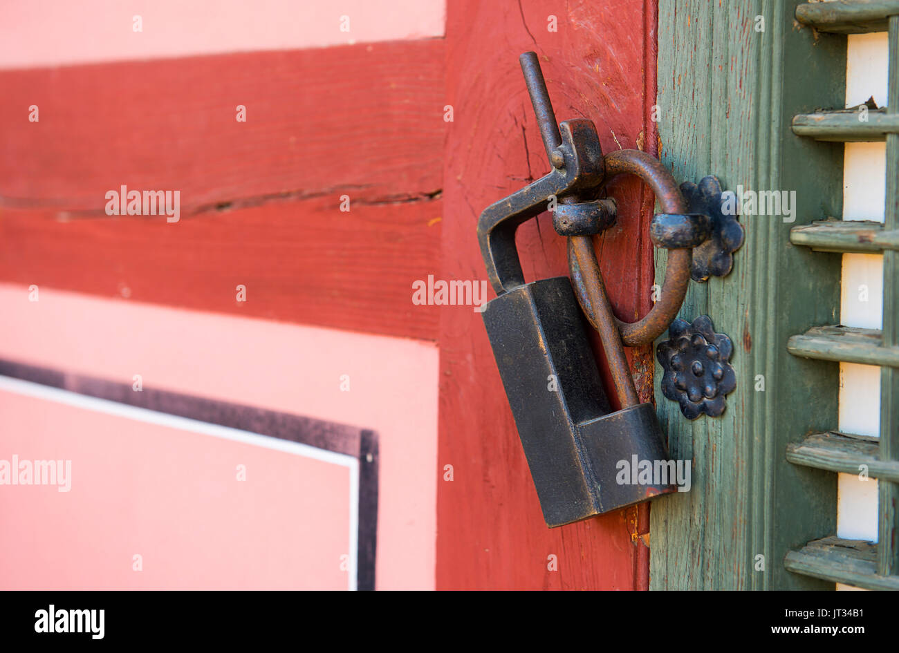 Old rusty lock on the wooden gate Stock Photo