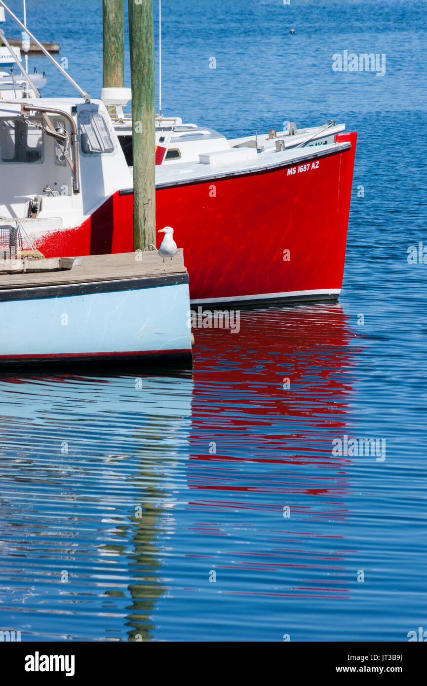 Hull of boat reflected on water. Gloucester Harbor, Cape Ann, Massachusetts. Stock Photo