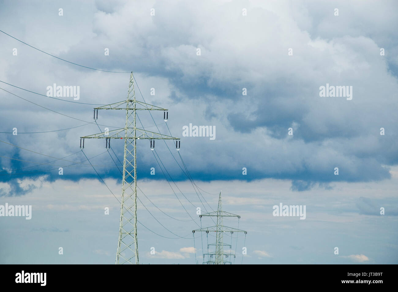 overhead power lines at cloudy sky Stock Photo - Alamy