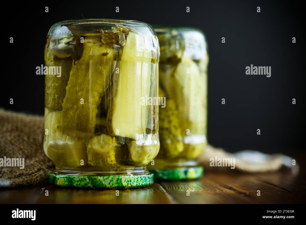 Home preservation. Canned in a glass jar ripe cucumber . Stock Photo