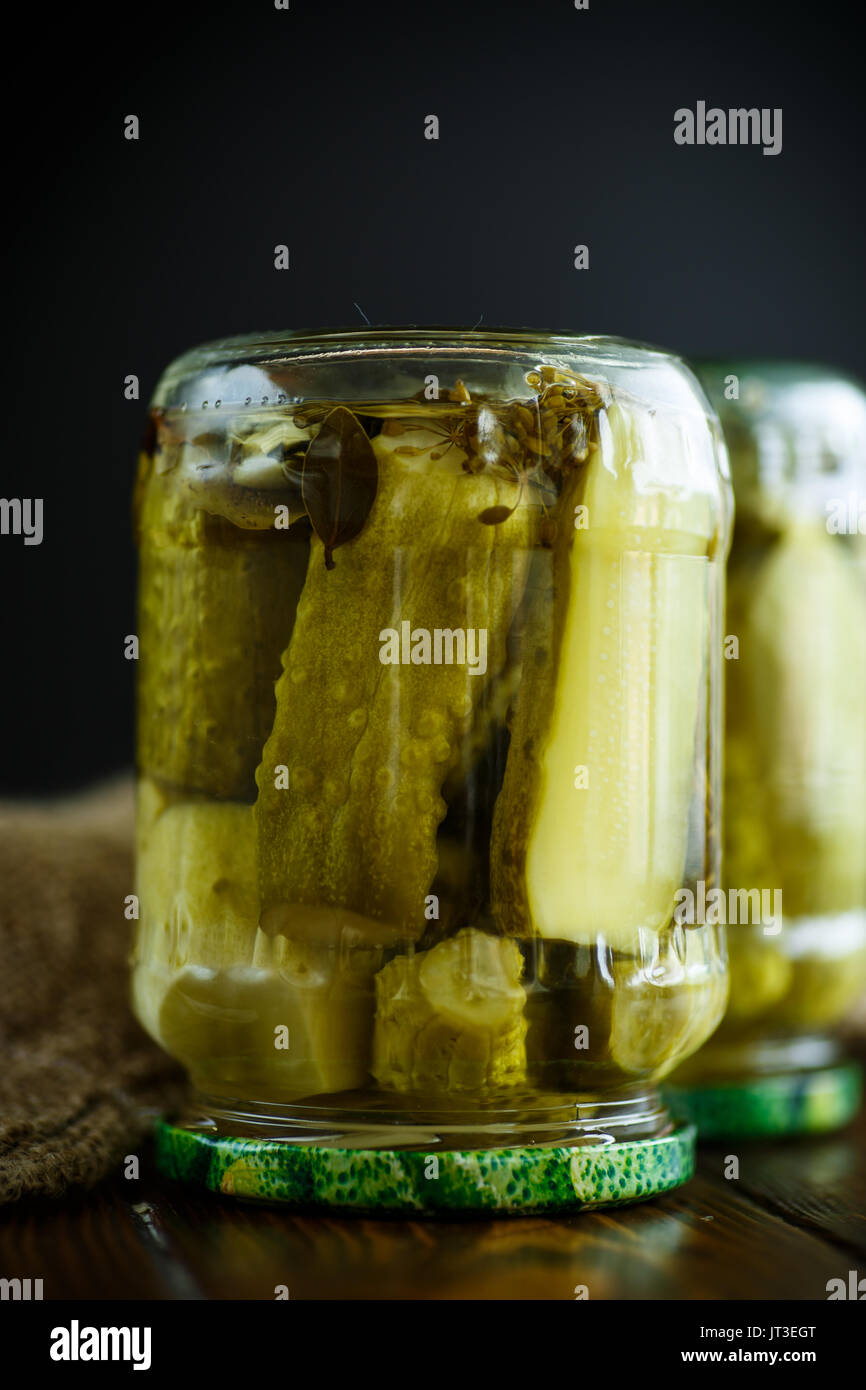 Home preservation. Canned in a glass jar ripe cucumber . Stock Photo