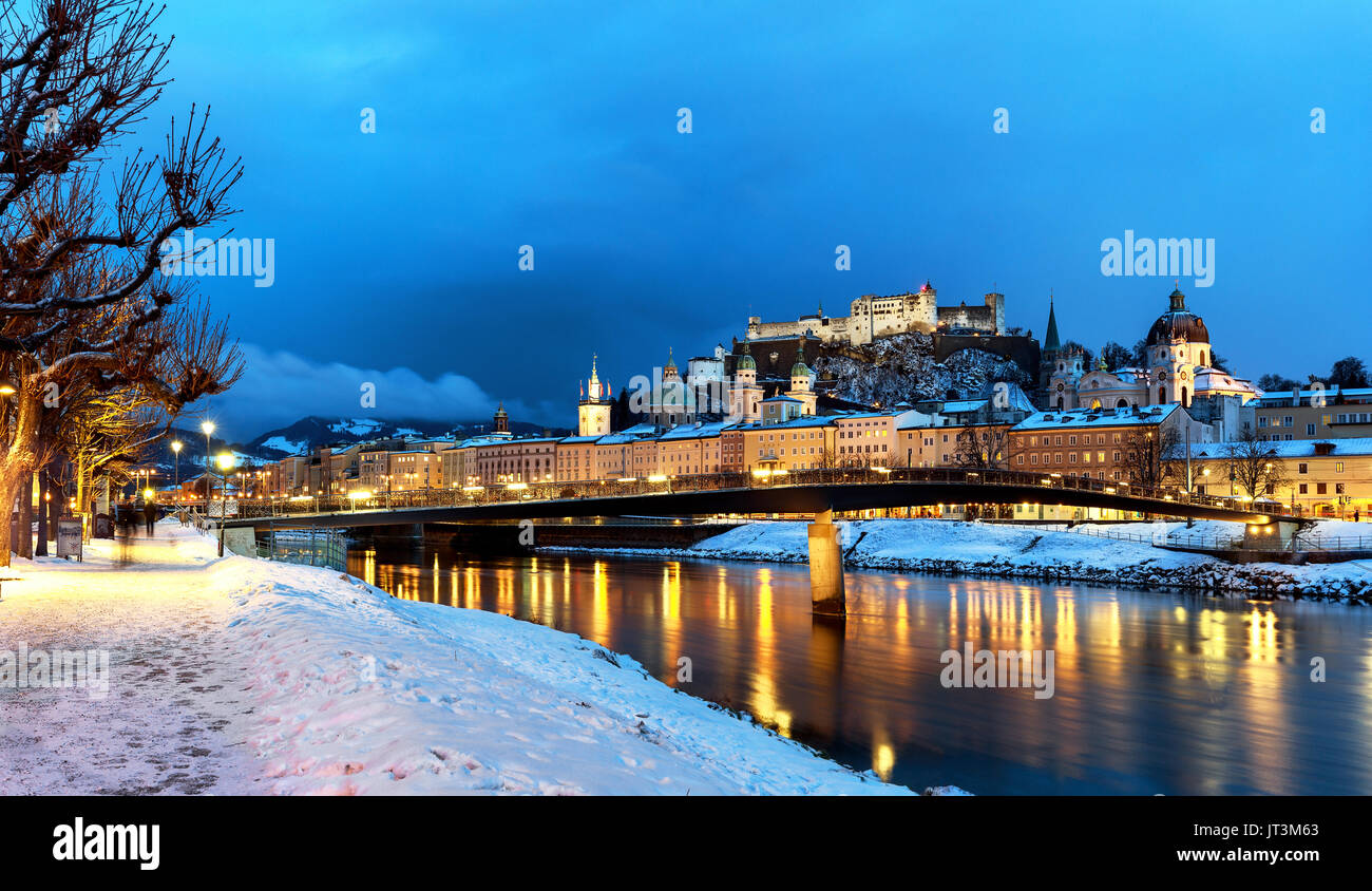 Classic view of the historic city of Salzburg with Salzburg Cathedral and famous Festung Hohensalzburg illuminated in winter, Salzburger Land, Austria Stock Photo