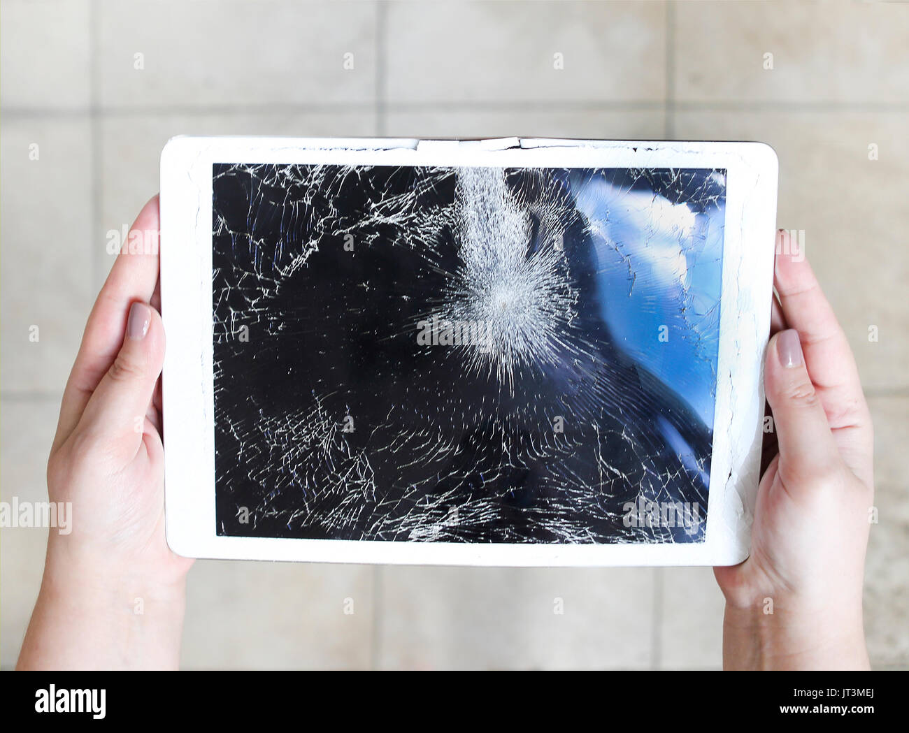 Damaged or broken tablet computer lcd display on the floor Stock Photo