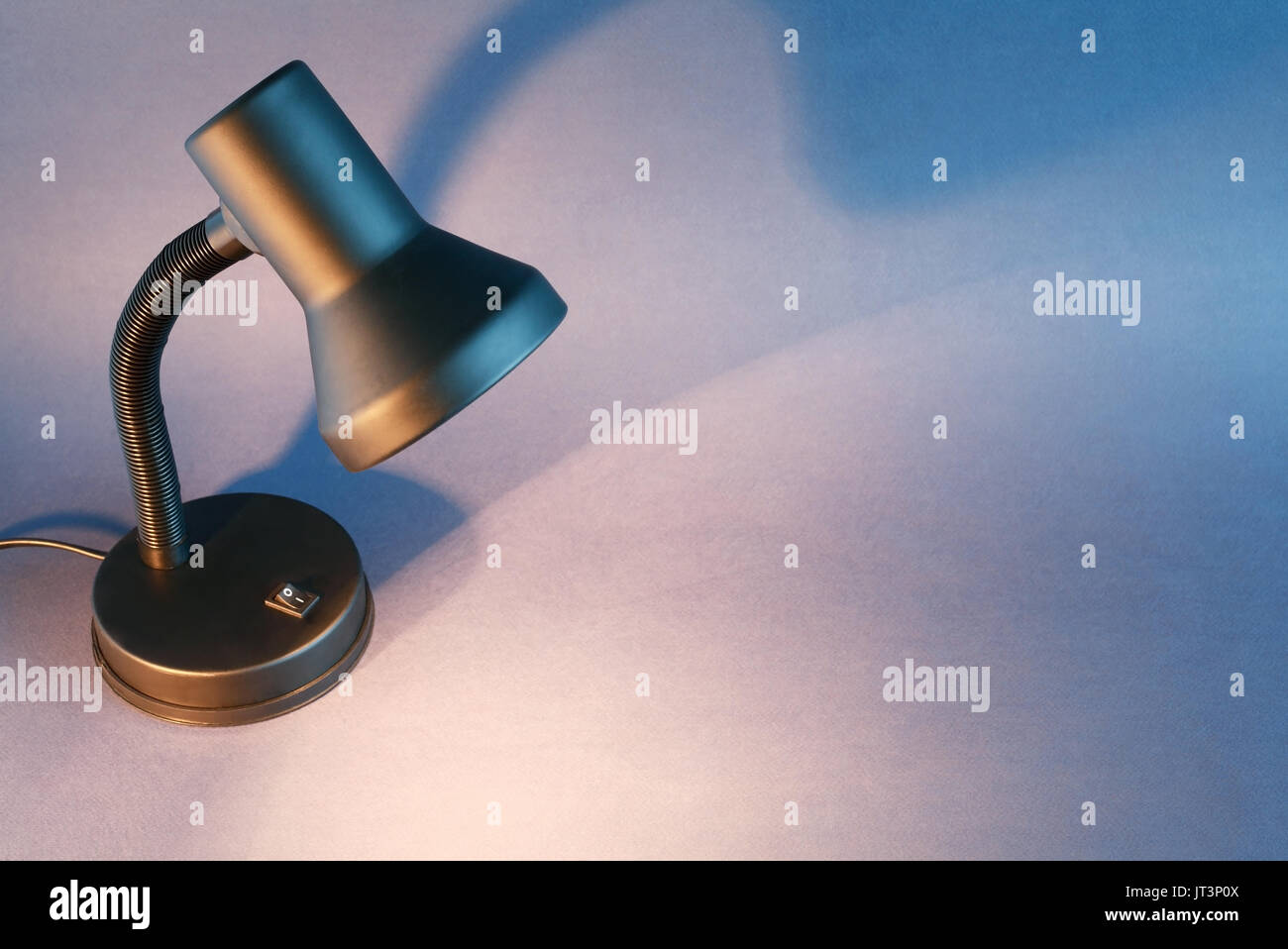 Black luminous desk lamp on dark background with copy space Stock Photo