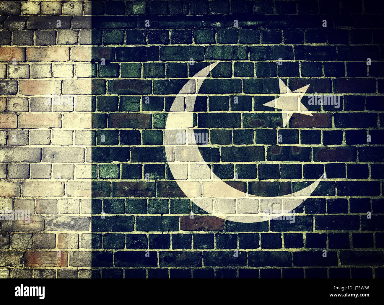 Faded Pakistani flag on an old brick wall background with a dark vignette Stock Photo