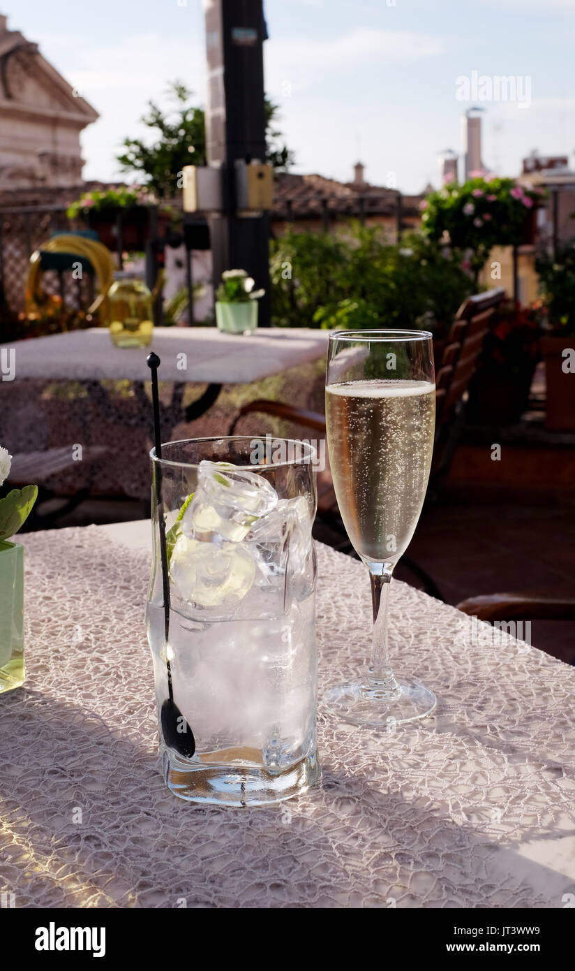 Rome Italy July 2017 - Gin and tonic and glass of Prosecco sparkling wine on rooftop terrace restaurant Stock Photo