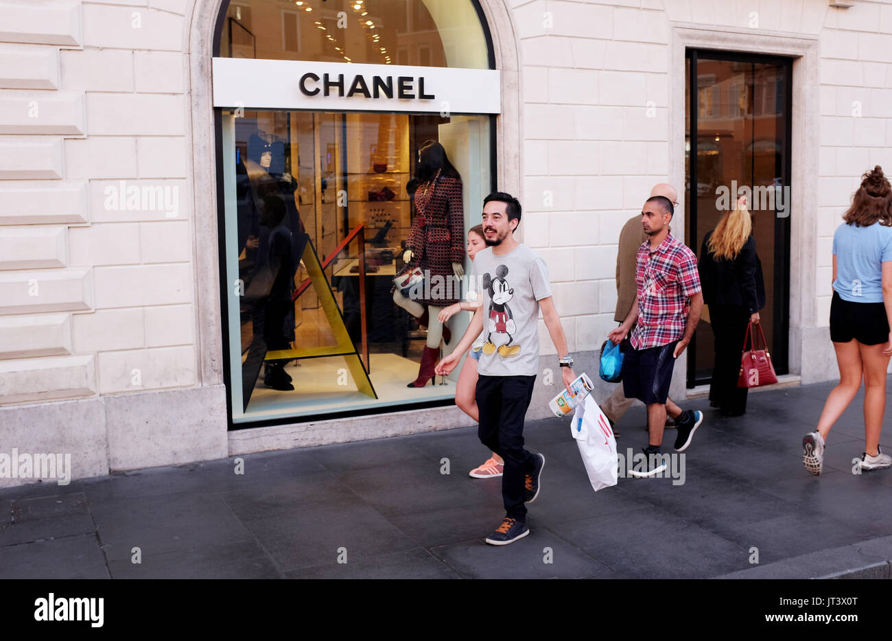 Rome Italy July 2017 - Shoppers pass by the famous Chanel shop in