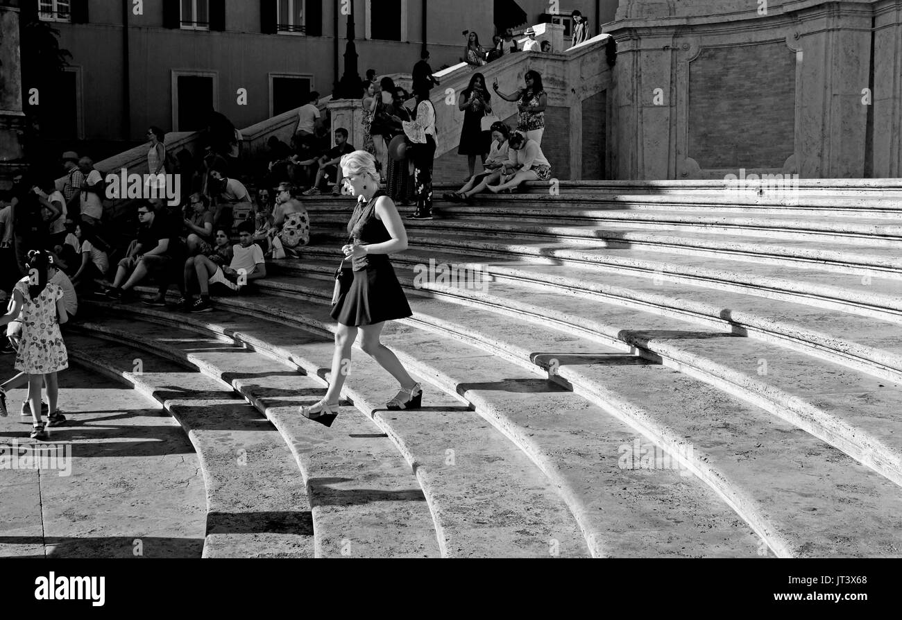 Rome Italy July 2017 - Female tourist casts a long shadow on The Spanish Steps in Tridente Photograph taken by Simon Dack Stock Photo