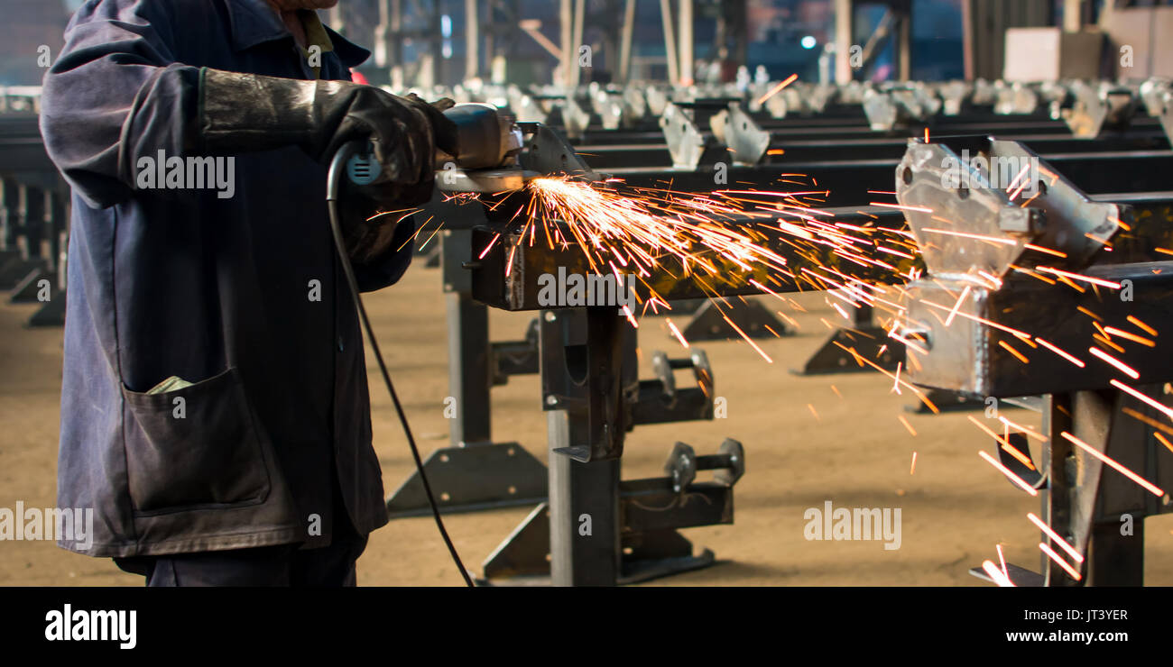 Worker grinding metal with a angle grinder Stock Photo Alamy