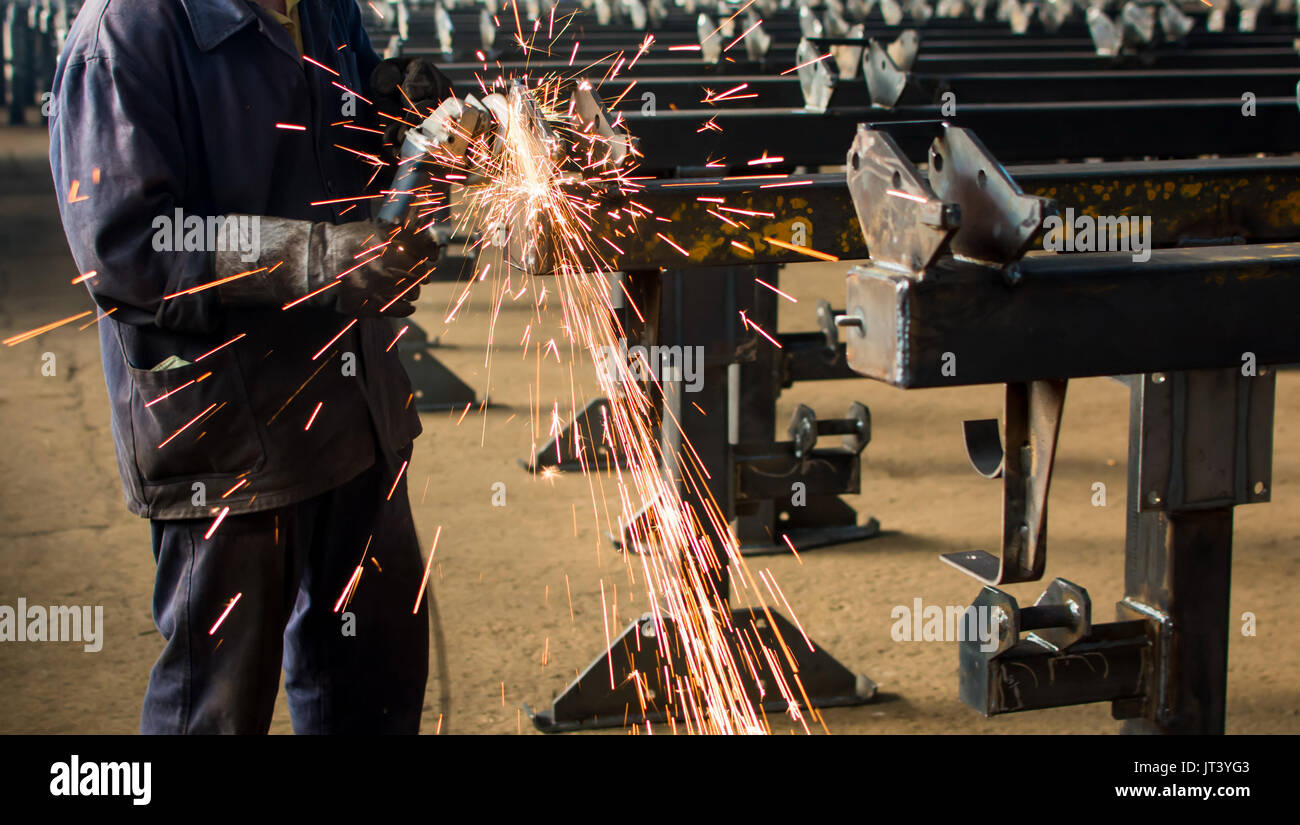 Worker grinding metal with a angle grinder Stock Photo Alamy