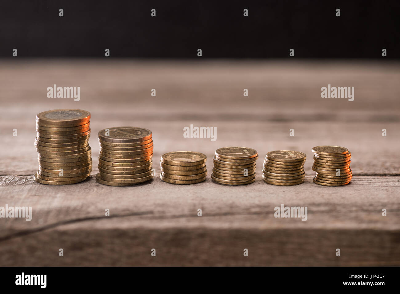stack of metal coins neatly composed lie on a white wooden table Stock  Photo - Alamy