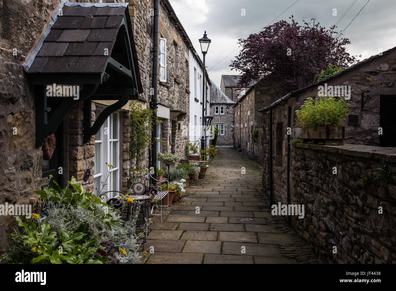 A small paved street with terraced cottages. Stock Photo