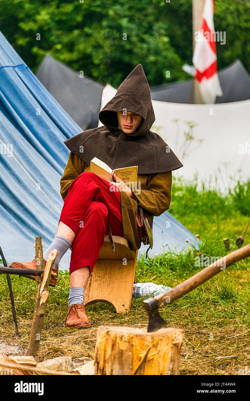 Urych, Ukraine - August 6,2016: Tustan Medieval Culture Festival in Urych, Western Ukraine, on August 6, 2016.Executioner reading a book before execut Stock Photo