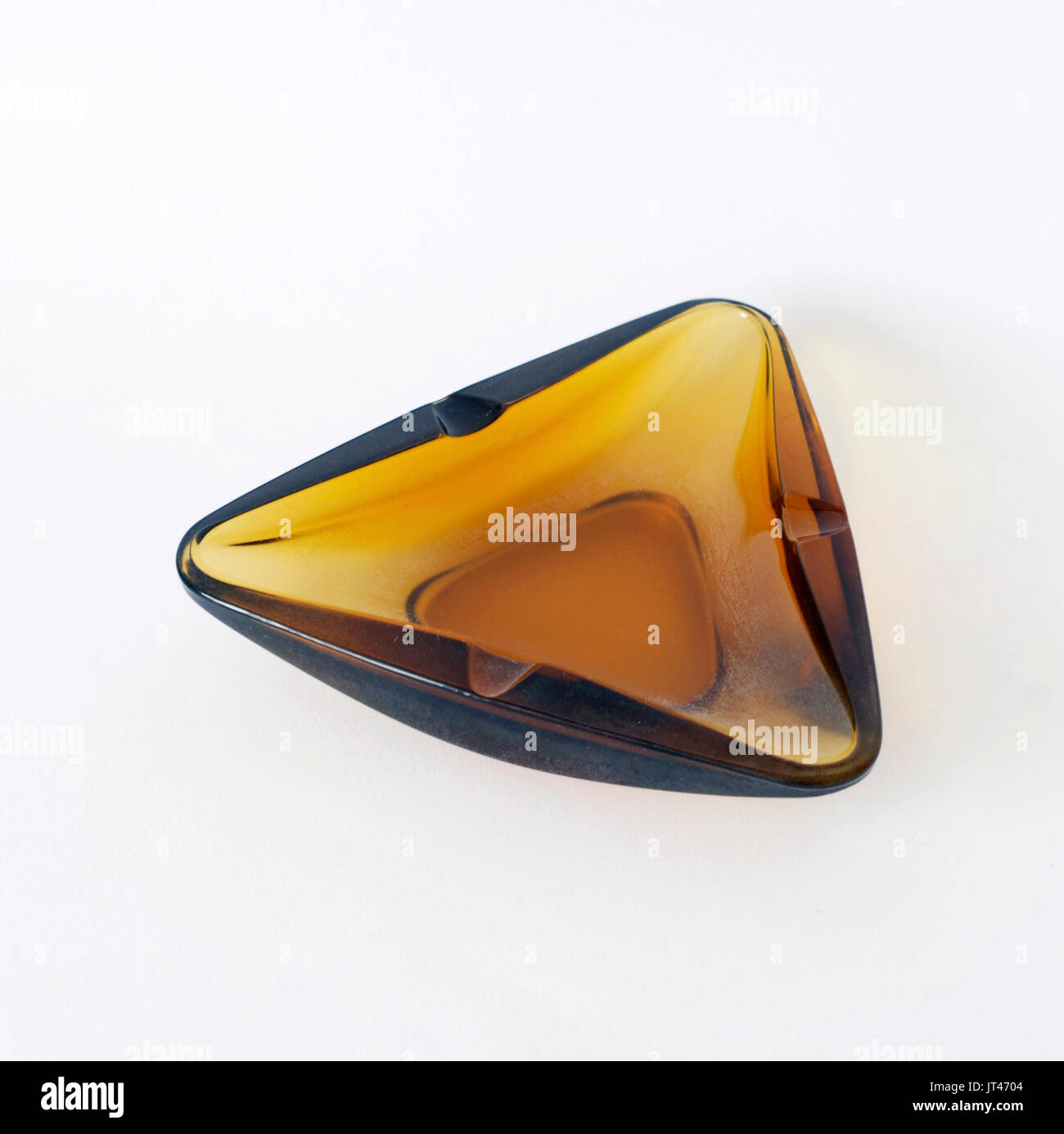Triangular vintage ashtray amber color triangular. Original from the 60s or 70s Design Stock Photo