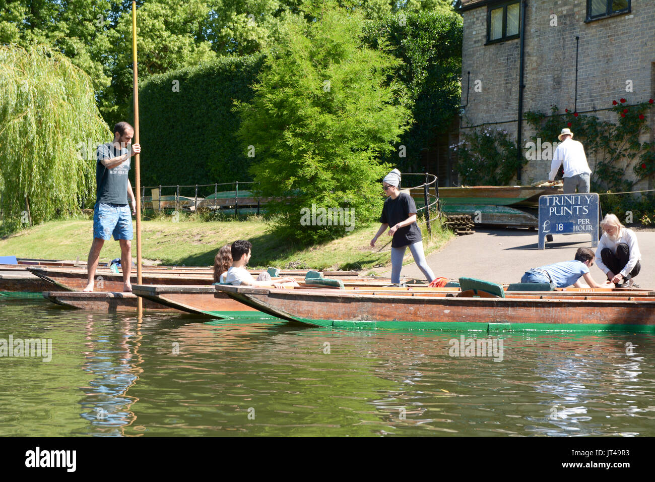 Punt boats for hire at Trinity College in Cambridge England - this is the only college that allows the public to hire boats to punt themselves on the  Stock Photo