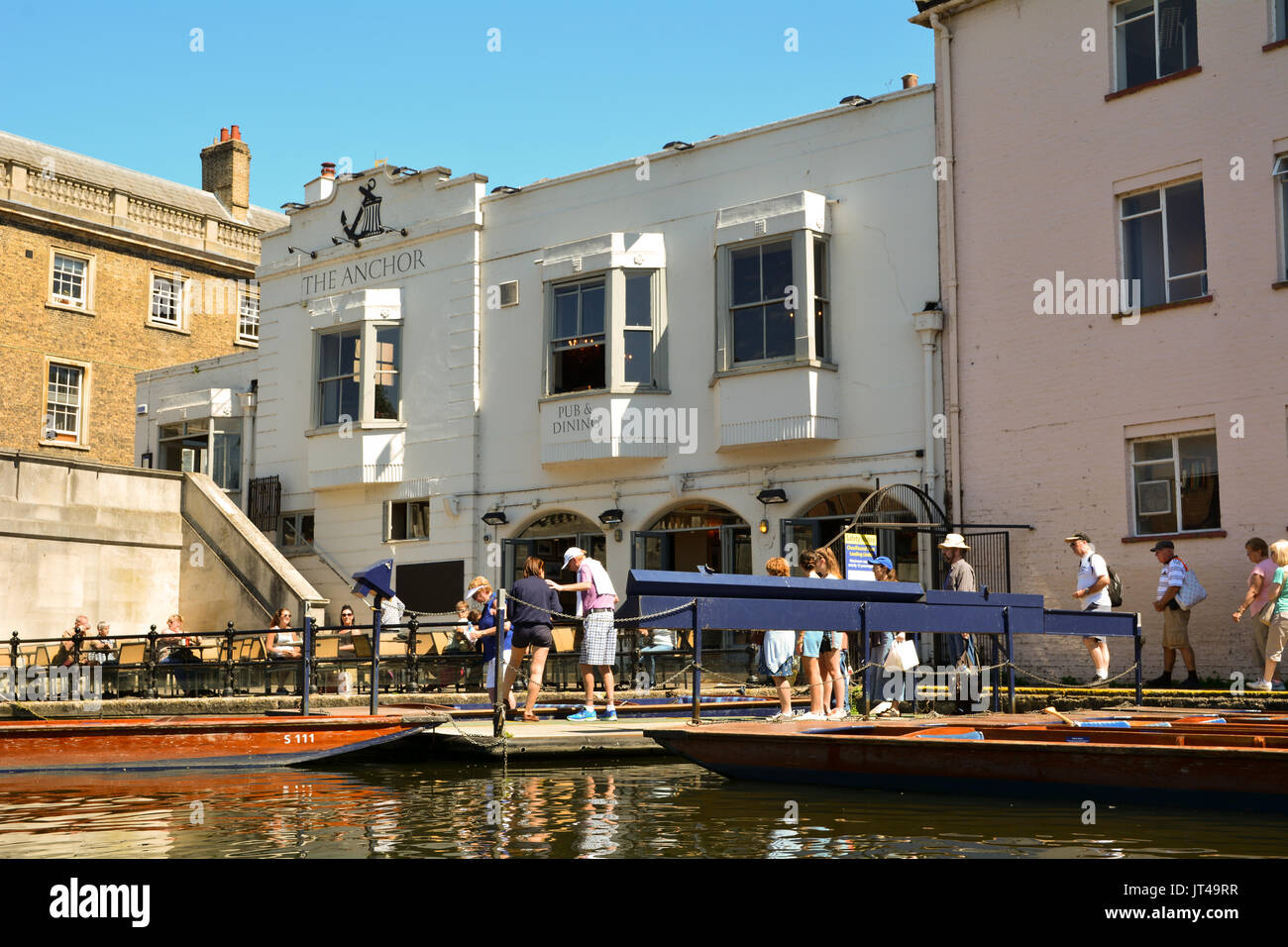 Customers at The Anchor public house on the banks of the River Cam in