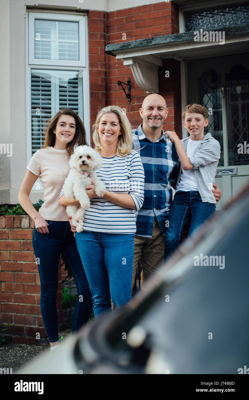 Family standing outside house moving hi-res stock photography and ...