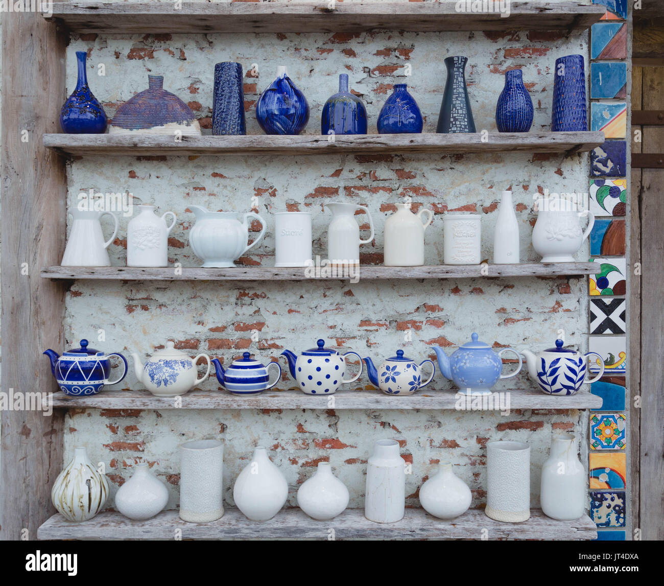 Ceramic vases are placed on shelves next to walls to decorate the house