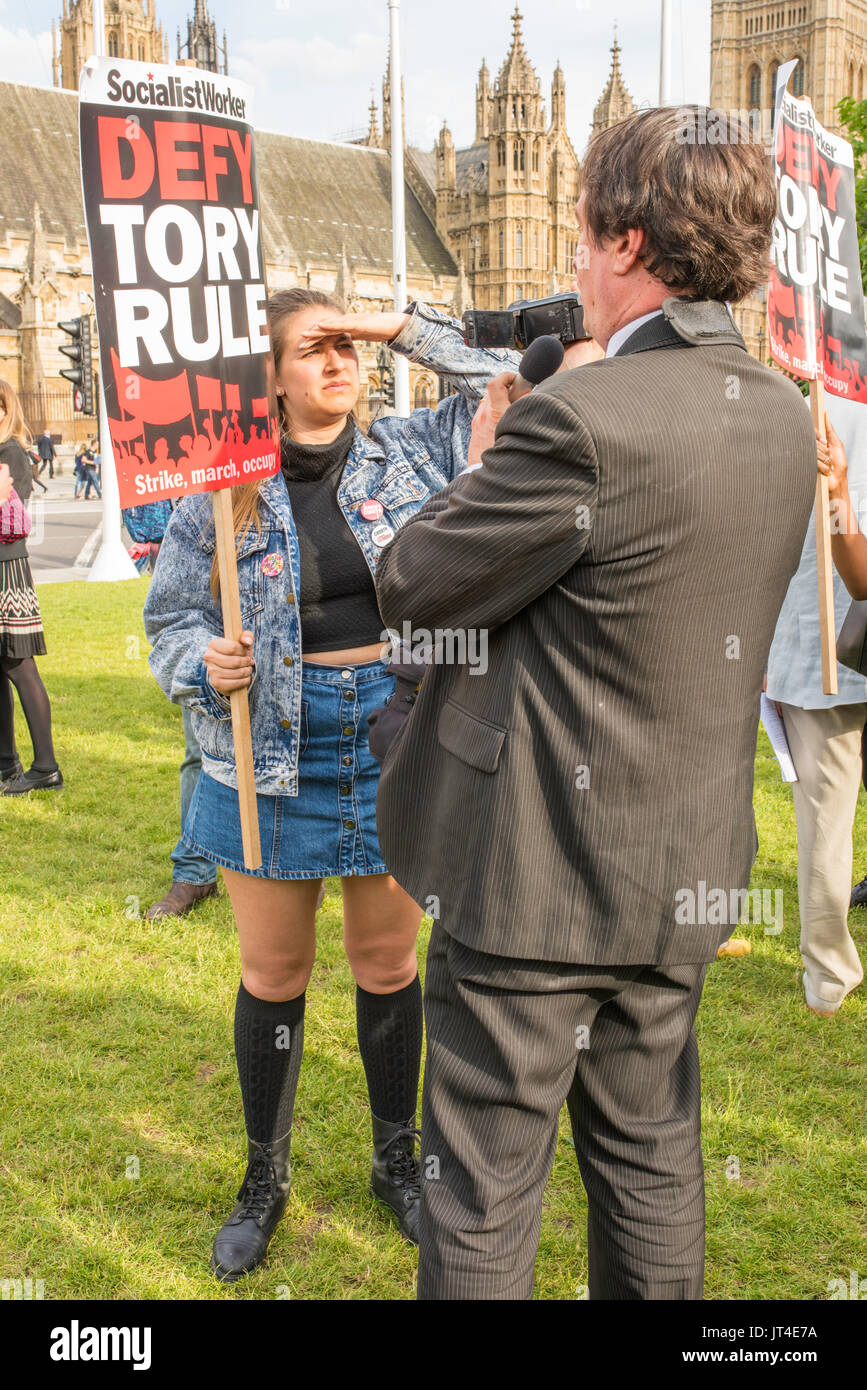 Woman protester with a banner supporting the 'Socialist Worker' in Parliament Square, London, UK. Stock Photo