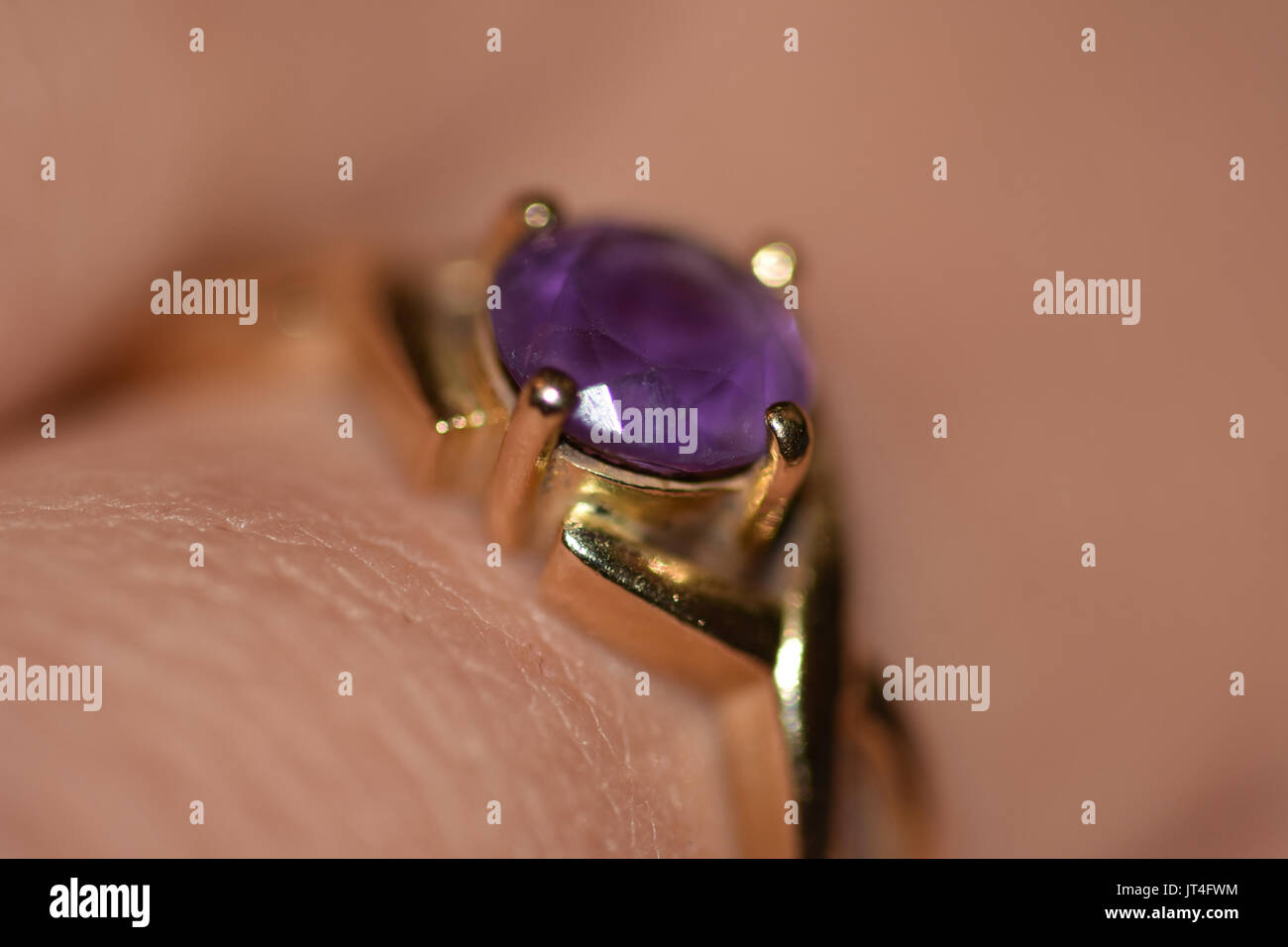 purple gem ring on finger Stock Photo