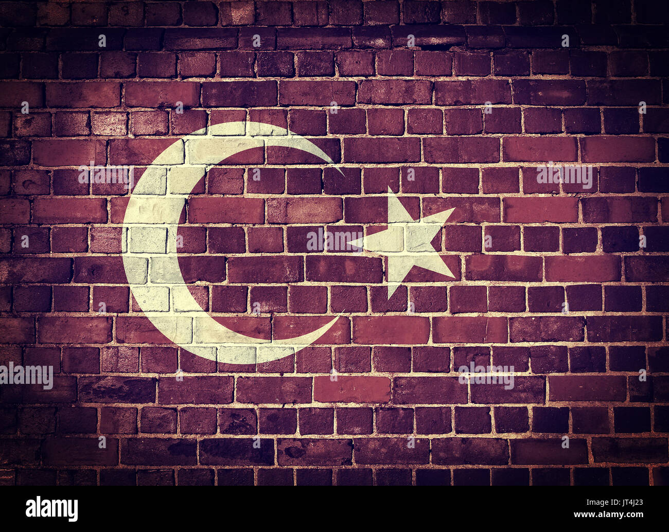 Faded Turkish flag on an old brick wall background with a dark vignette Stock Photo