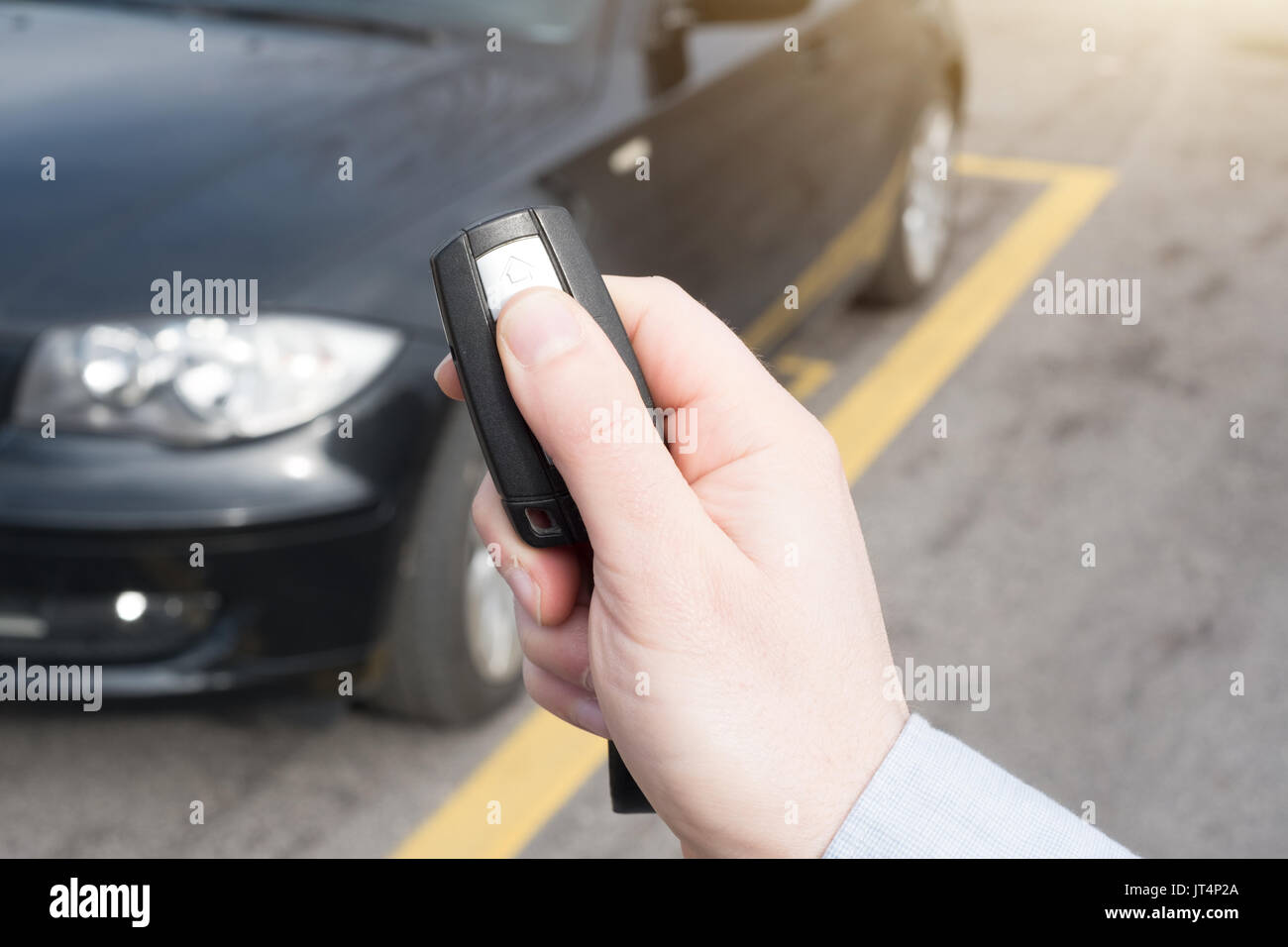 Hand holding a car alarm key with antitheft Stock Photo Alamy