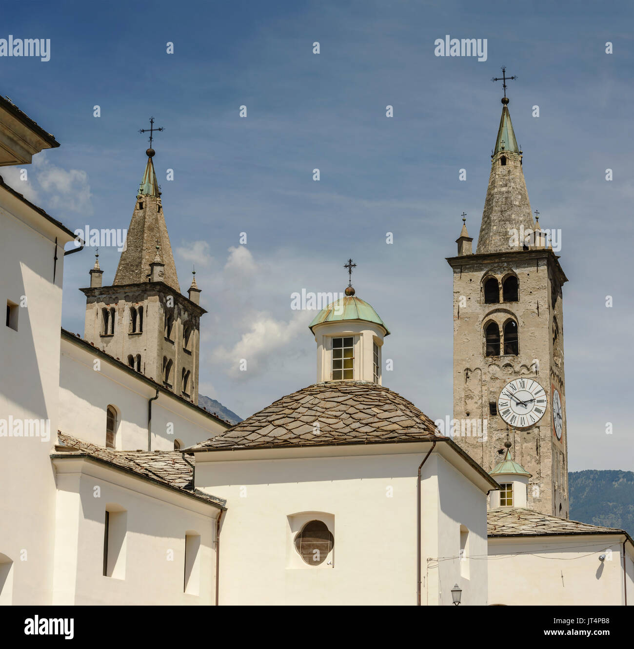 stone medieval bell towers of Cathedral , shot on a bright summer day at Aosta mountain town, Italy Stock Photo