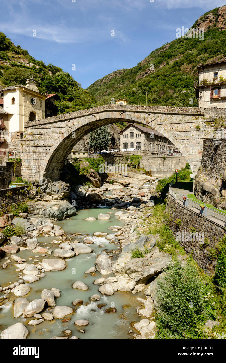 ancient Roman bridge over Lys river, shot on a bright summer day at Pont St Martin, Aosta valley,  Italy Stock Photo