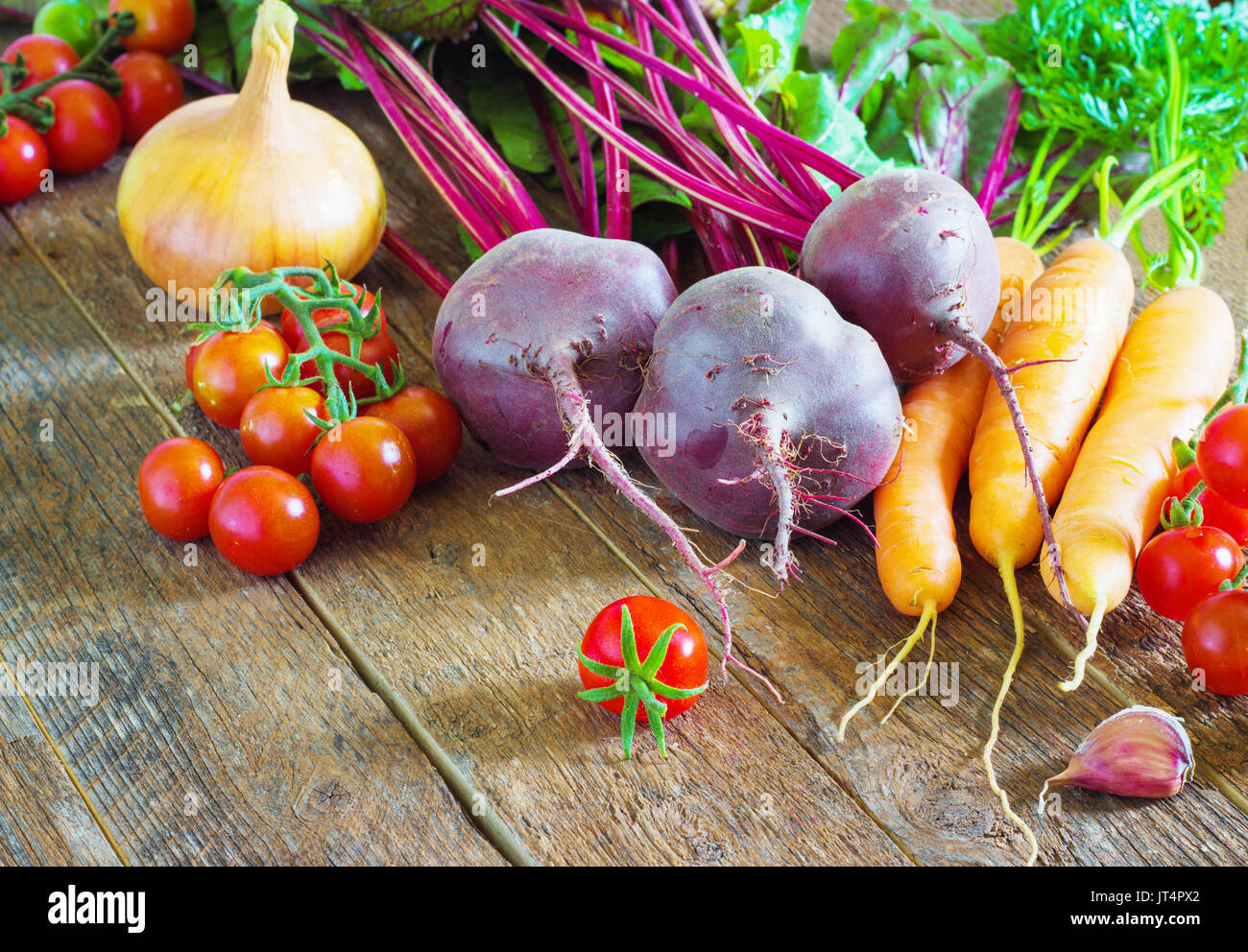 ingredients for pasta on a wooden table, cherry tomatoes and pasta Stock Photo