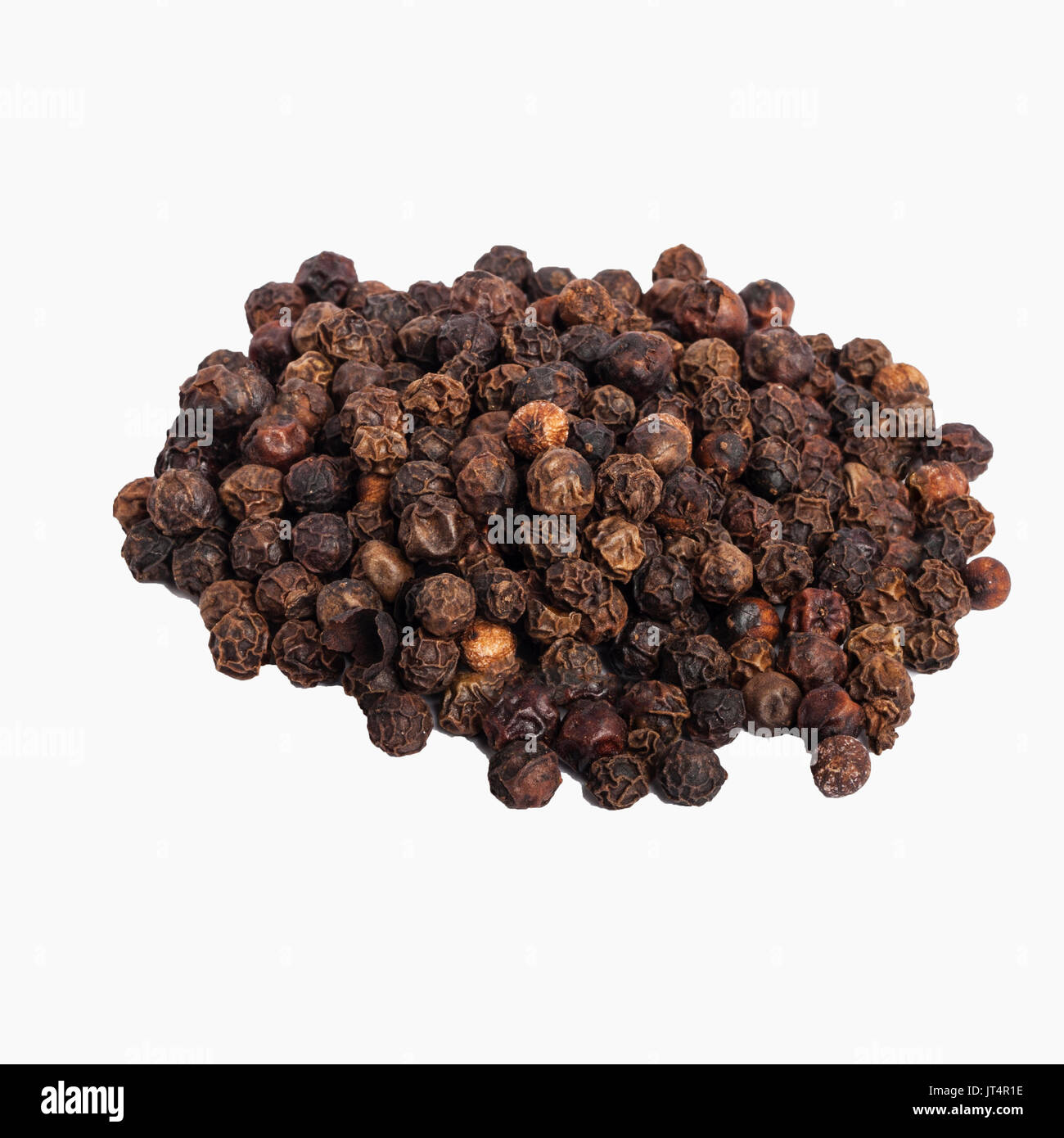 Black Peppercorns on a white background Stock Photo
