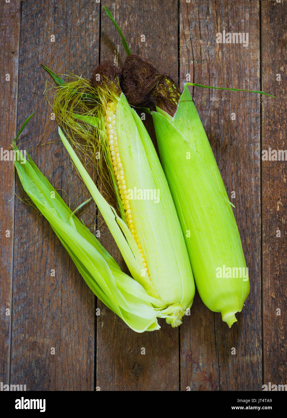 A corn cob on aold retro wooden table Stock Photo Alamy