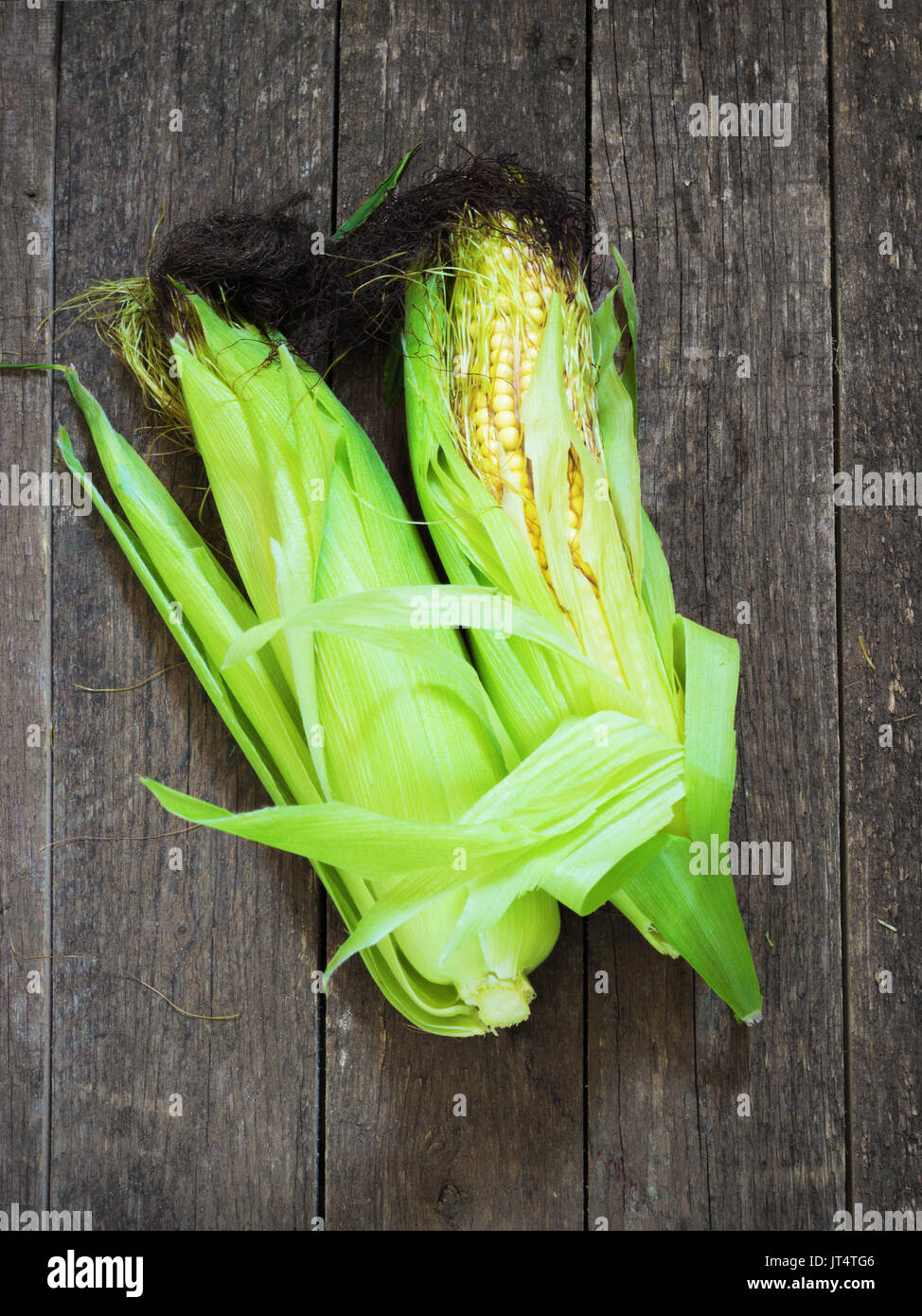 A corn cob on aold retro wooden table Stock Photo Alamy