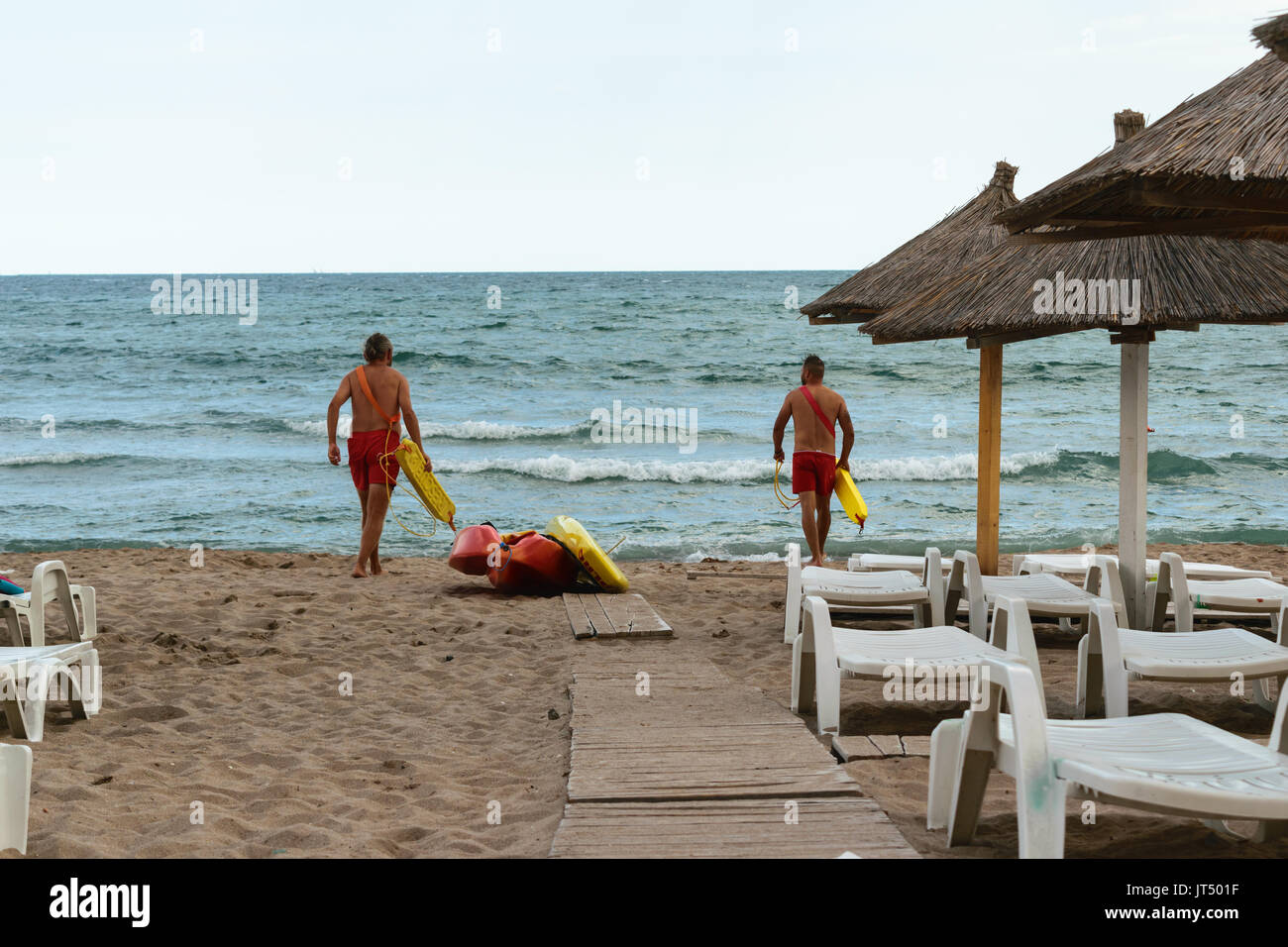 Neptun, Romania - July 8, 2017: Two Lifeguards Enter In The Black Sea 