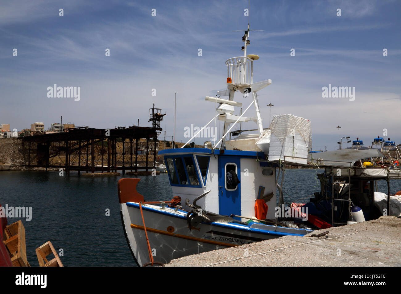 Lavrio Port Attica Greece Fishing boat and old Iron Quay of the French Mining Company in 1887 now a monument of industrial heritage Stock Photo