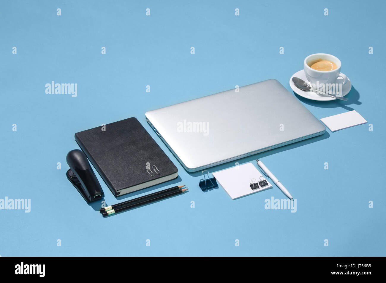 The laptop, pens, phone, note with blank screen on table Stock Photo