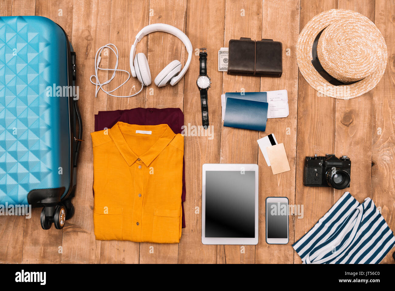 Flat lay of summer vacation things neatly organized on wooden background. Travel concept.  Stock Photo