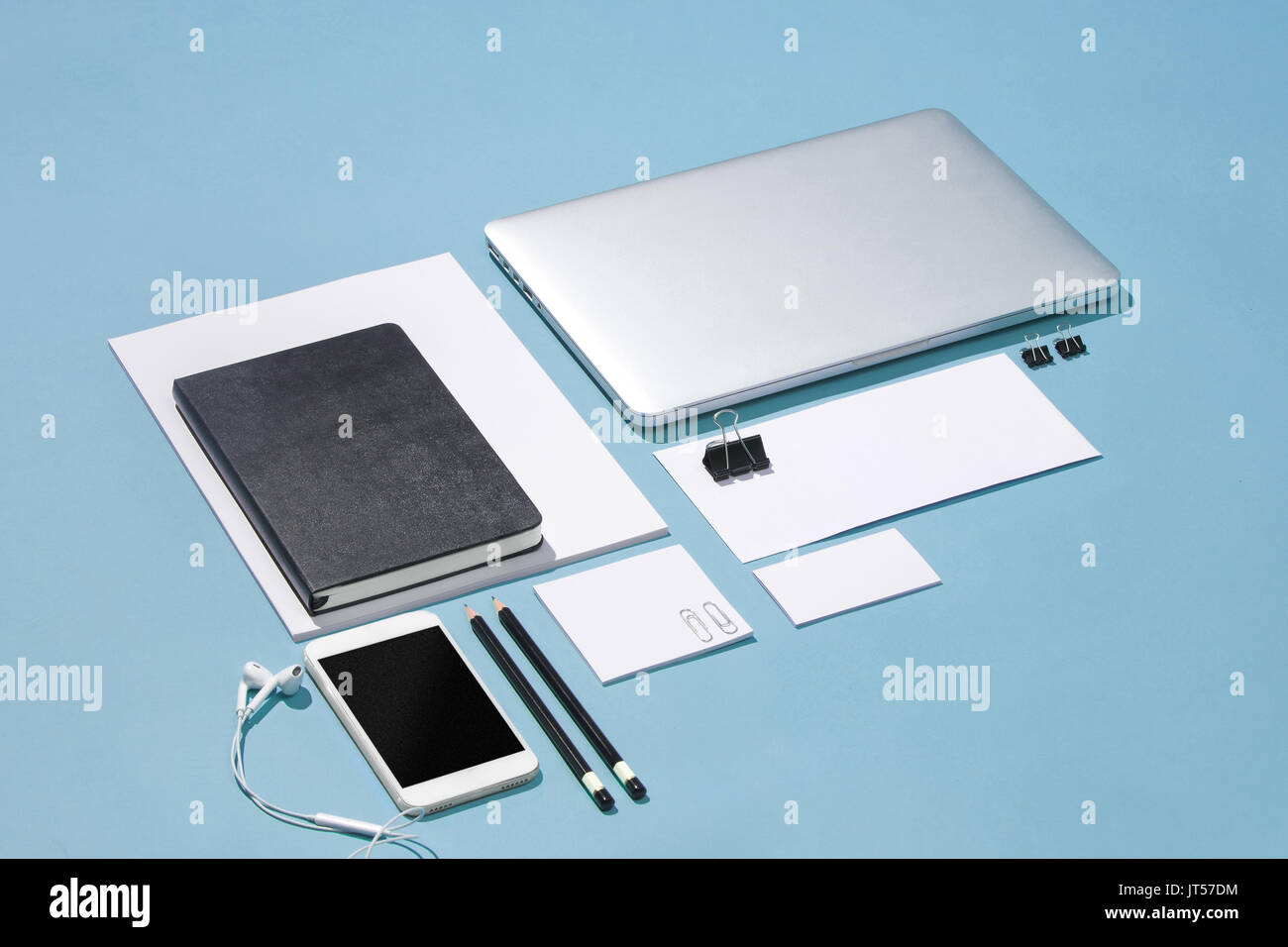 The laptop, pens, phone, note with blank screen on table Stock Photo