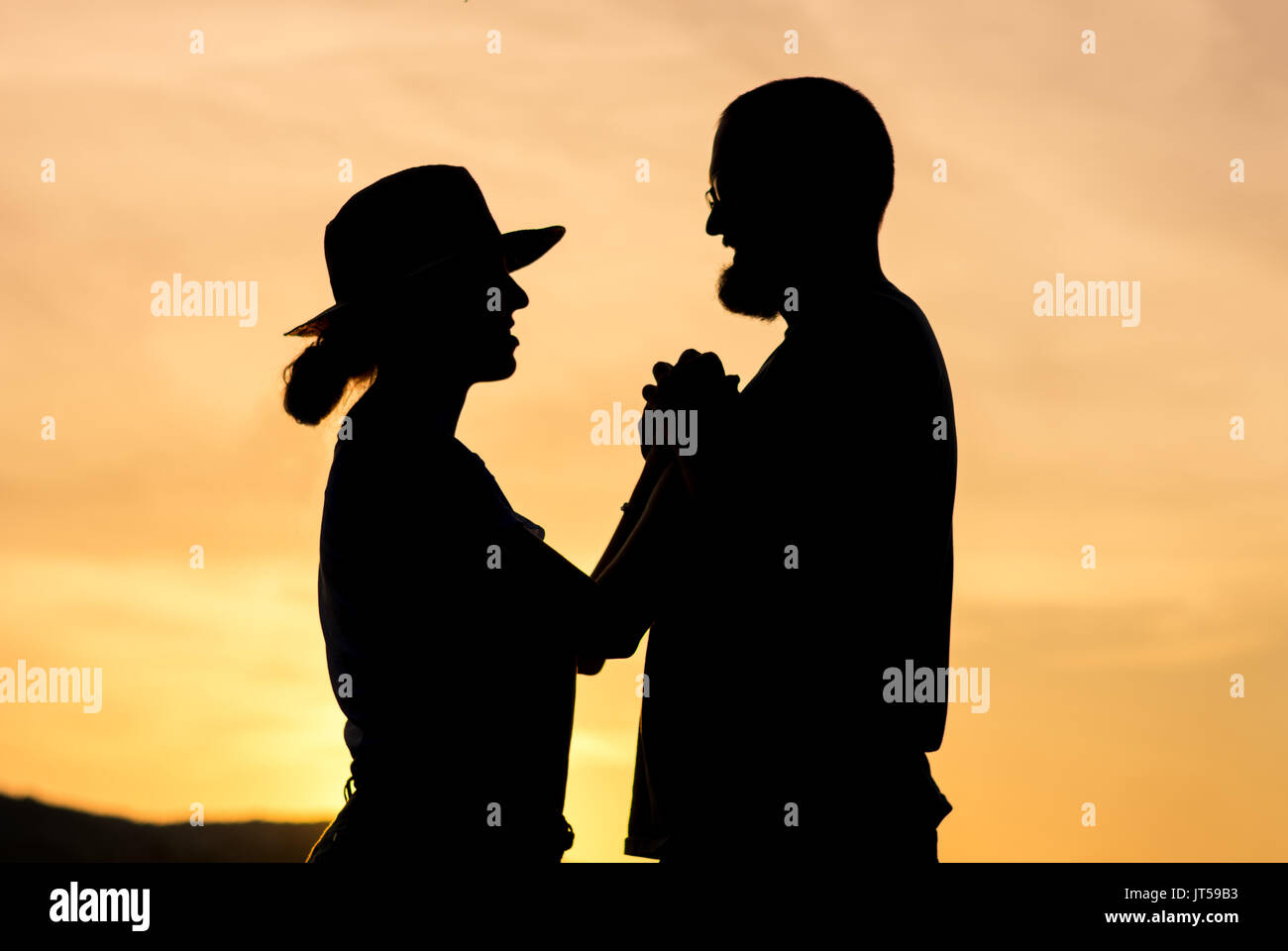 Couple holding hands sunset silhouette hi-res stock photography and ...