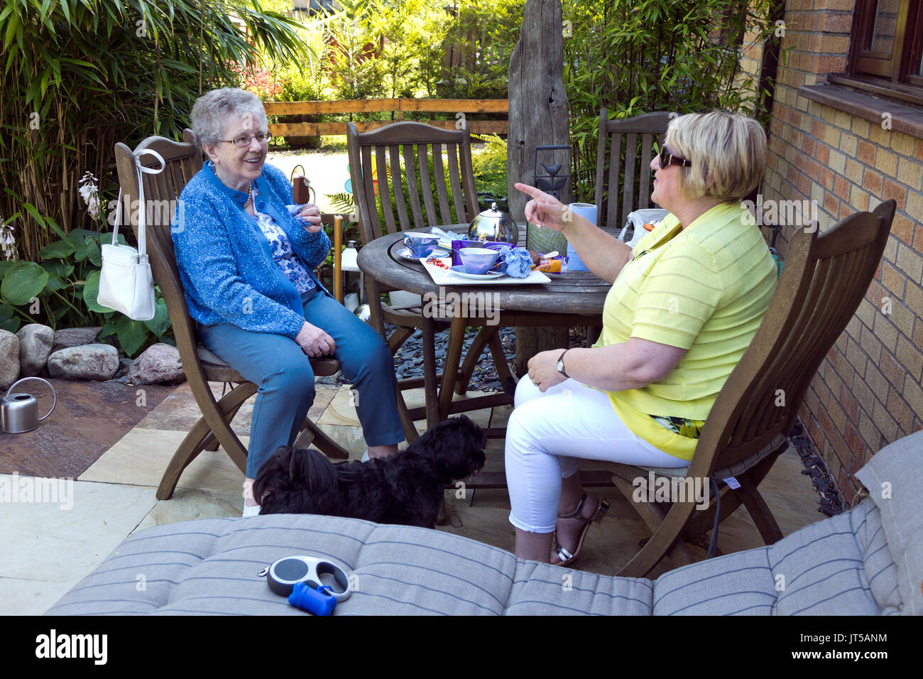 older woman and daughter eating outdoors Stock Photo