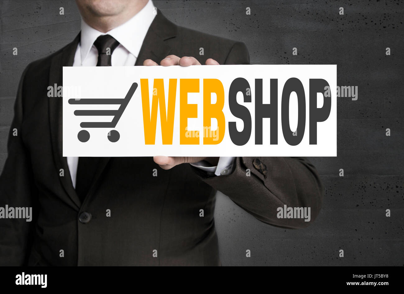 Webshop sign is held by businessman. Stock Photo