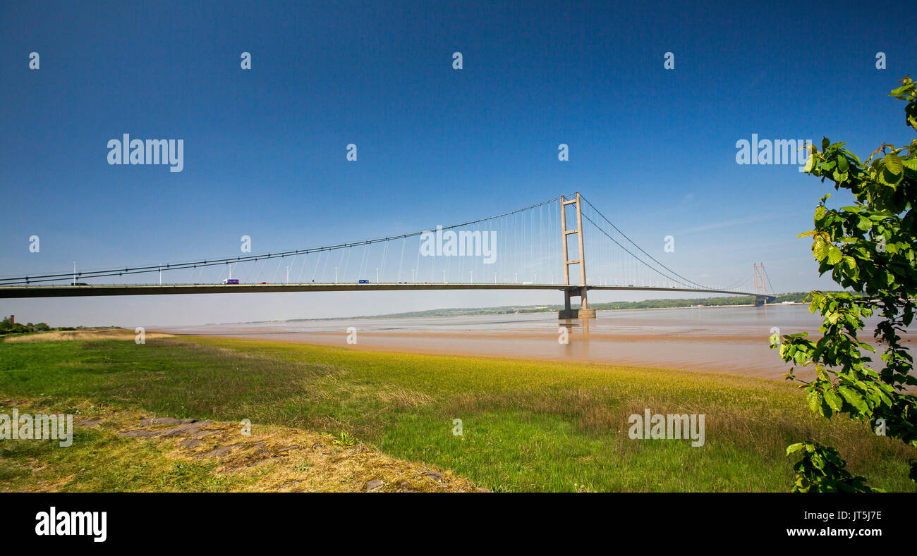 Panoramic view of long suspension bridge over Humber River under blue sky near Kingston Upon Hull, England Stock Photo