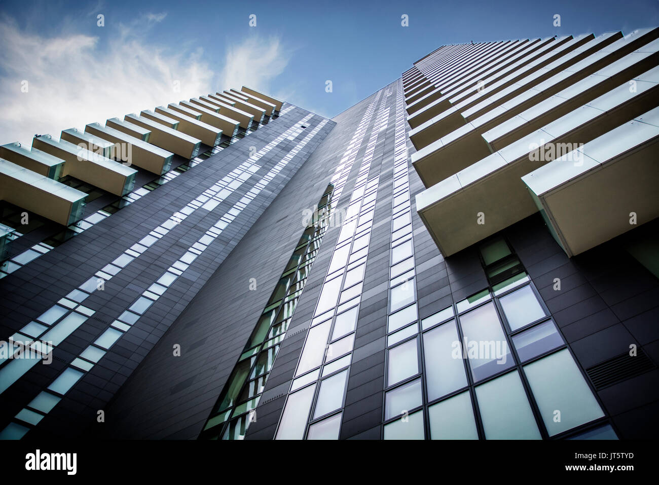 Skyscaper in a city seen from below under a blue sky Stock Photo - Alamy