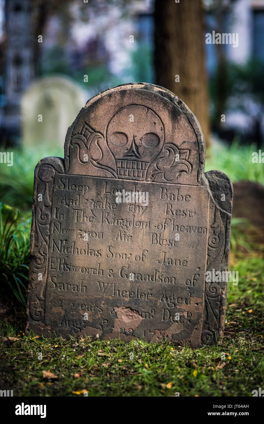 NEW YORK, USA - October 14, 2016. Trinity Church Cemetary and Closeup of a gravestone showing engraved skull, Manhattan, New York. Stock Photo