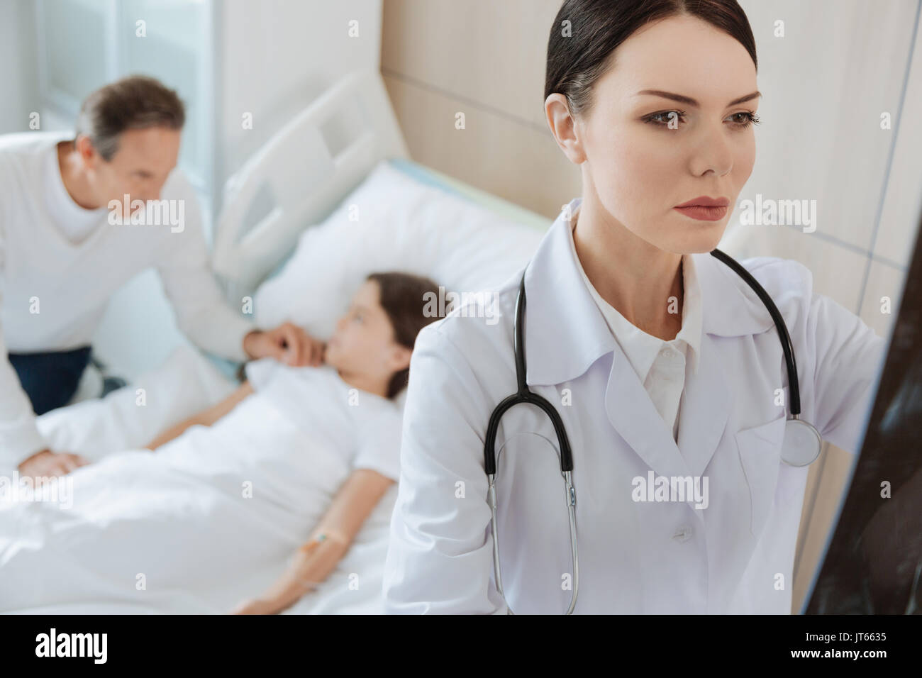 Beautiful smart doctor studying an X ray photo Stock Photo