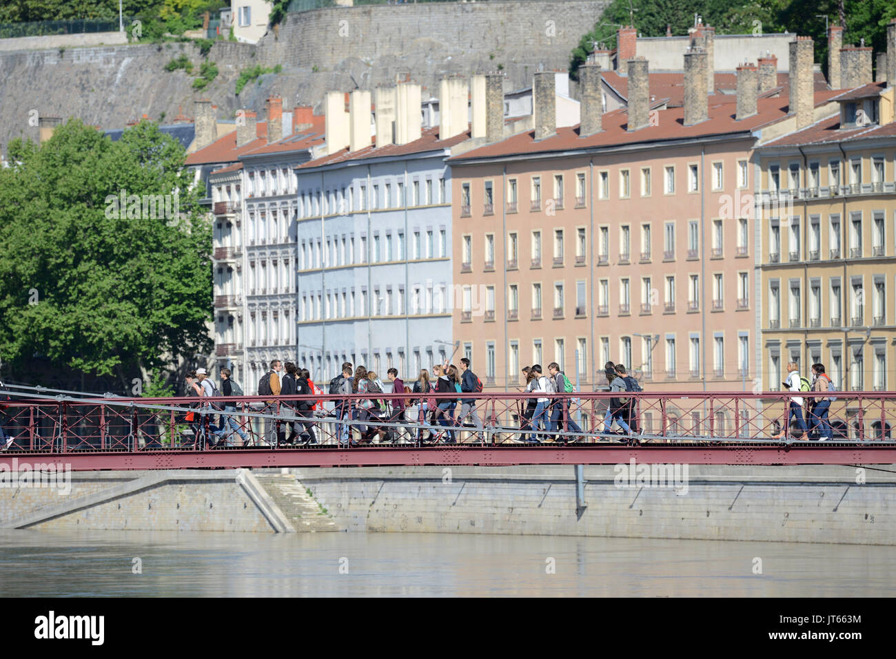 Lyon (south-eastern France): real estate, buildings along the Quais de Saone walkway, with pedestrians on the footbridge of the Law Court and building Stock Photo