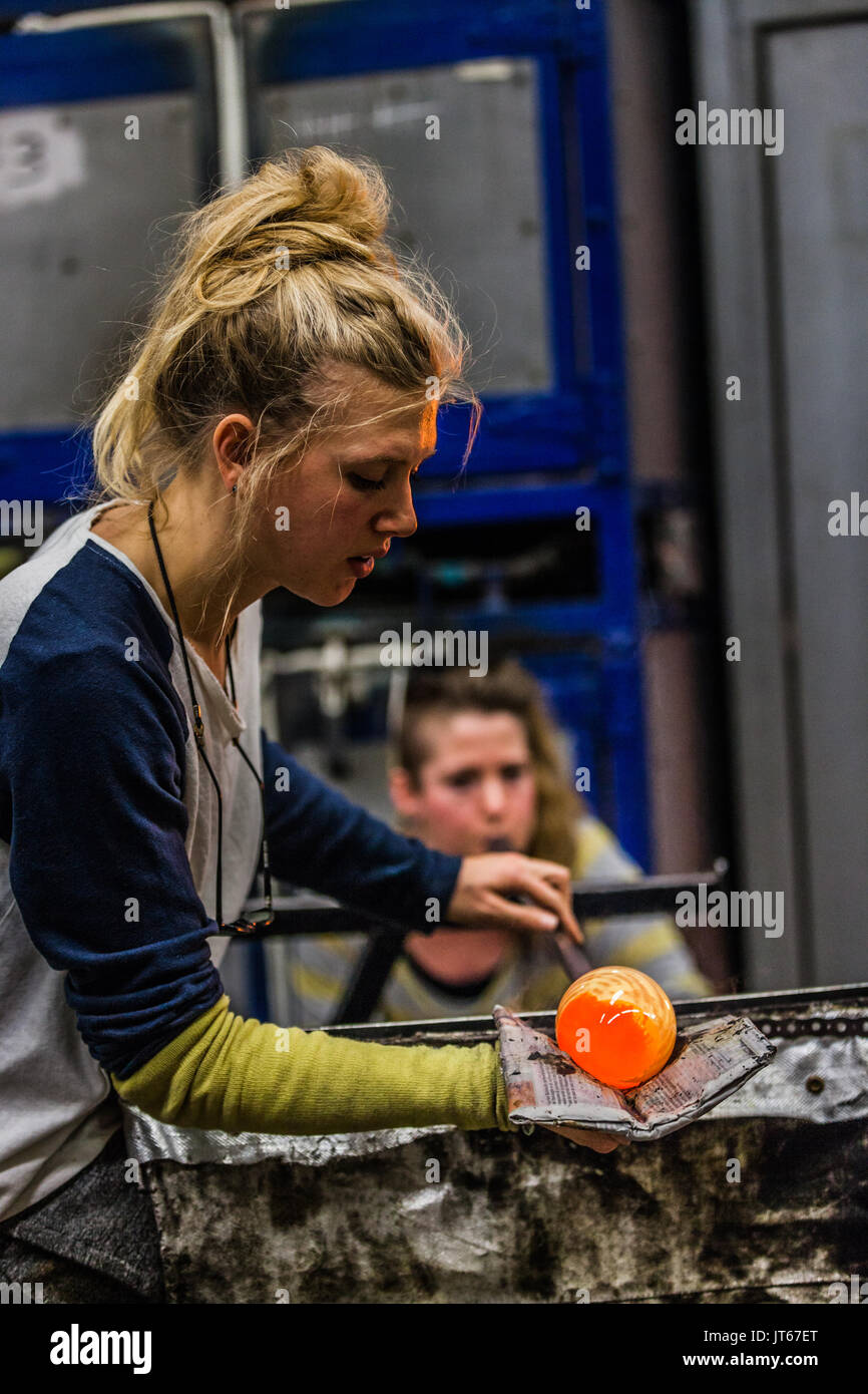 Glass Blowing Two Women Shaping glass on the Blowpipe Stock