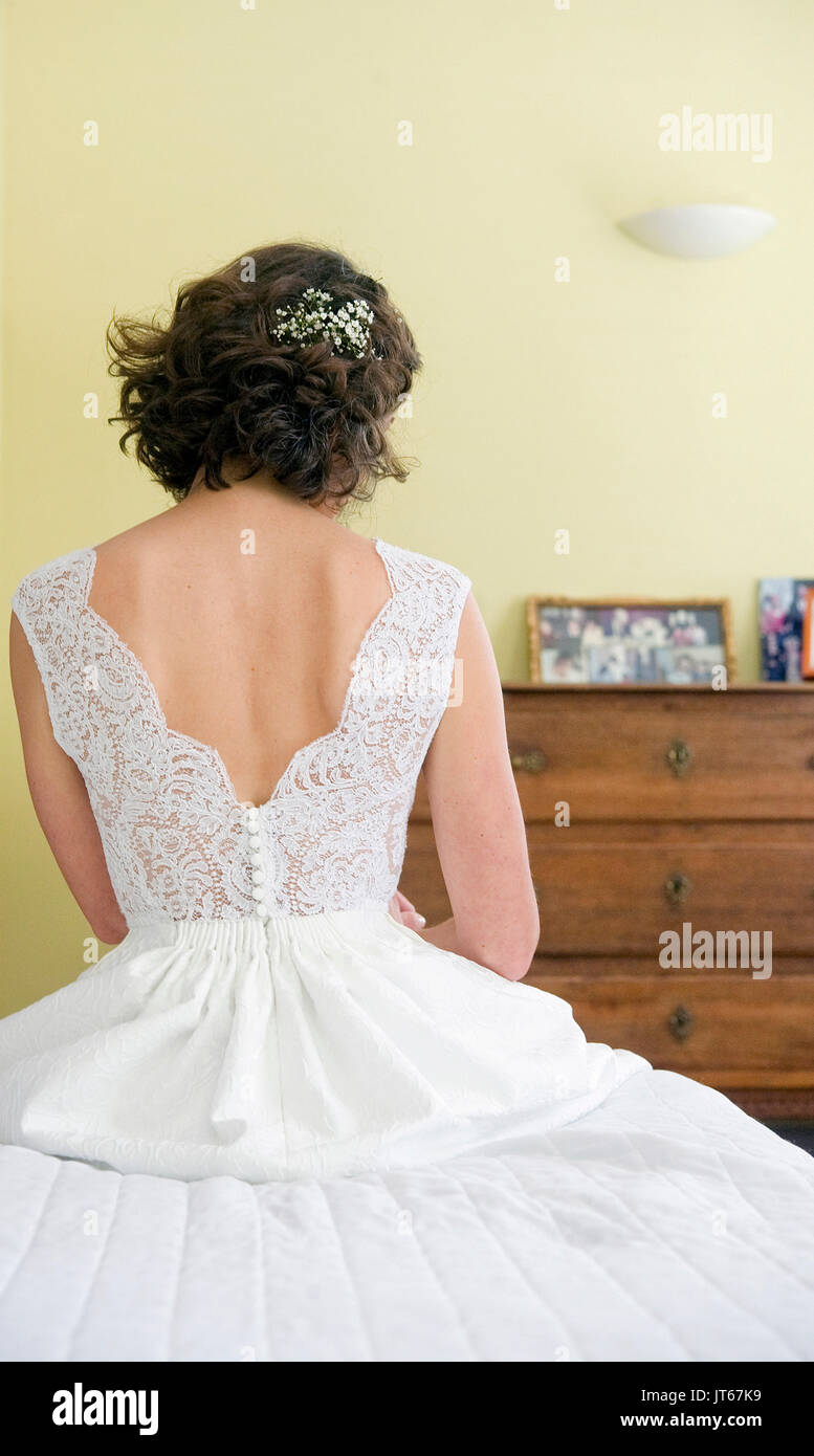 Illustration on weeding: woman viewed from behind wearing a wedding gown Stock Photo