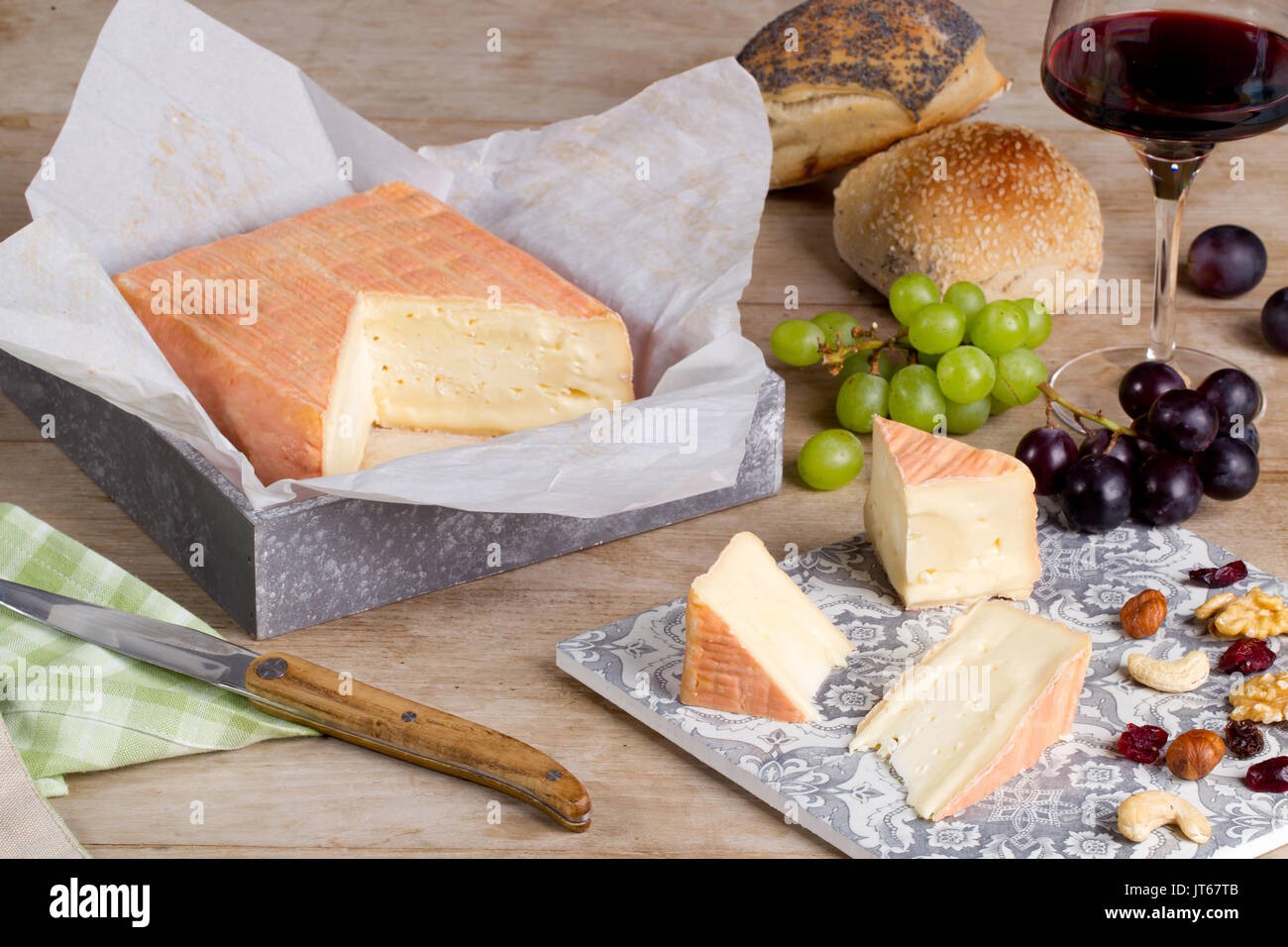Cheese from northern France: Maroilles cheese, unpasteurized farm cheese, soft cheese with an orangey-red washed rind. Stock Photo